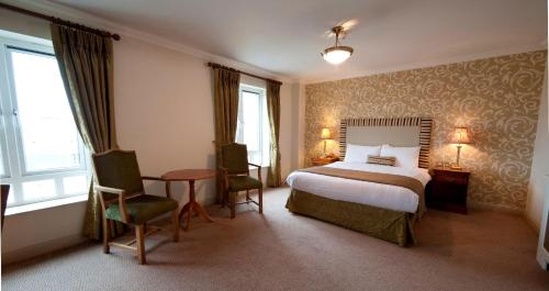 巴尔布里根布莱肯科特酒店的酒店客房带一张床、一张桌子和椅子