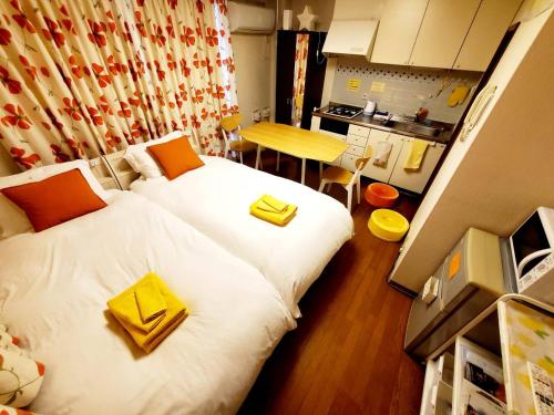 神户petit room201三宮10mim的一间小房间,配有两张床和厨房