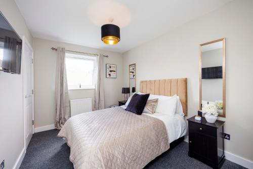 滨海绍森德Modern apartment -Perfect for Contractors & Families By Luxiety Stays Serviced Accommodation Southend on Sea的一间卧室配有一张床和一面大镜子