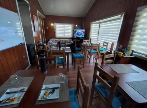 蒙特港Hospedaje y alojamiento Valencia的一间带桌椅和电视的用餐室