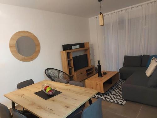 波利斯Valentinas apartment !的客厅配有木桌和电视。
