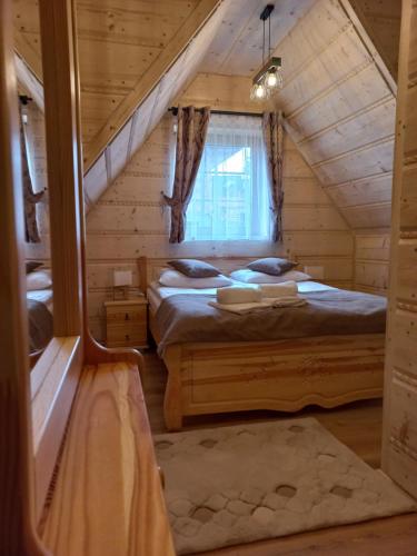 Bańska NiżnaDomek u kowola 2的小木屋内一间卧室,配有两张床