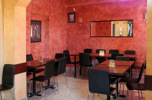 锡比乌Hotel Pamira的一间带桌椅和镜子的用餐室