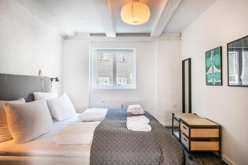哥本哈根The Churchill apartments by Daniel&Jacob's的一间卧室配有带白色枕头的床