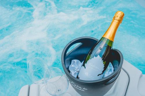 梅佐隆巴尔多CASA da CARMEN - Relax & Tradizione的一瓶香槟酒,放在酒杯旁的桶里