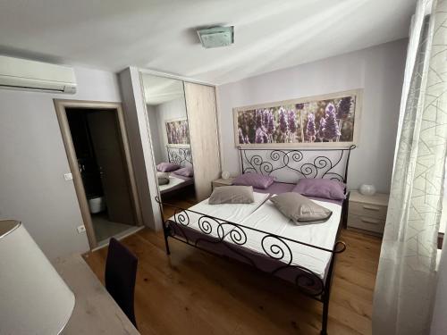 马卡尔斯卡Apartment Old Town Ivo的一间卧室配有一张床和一面大镜子