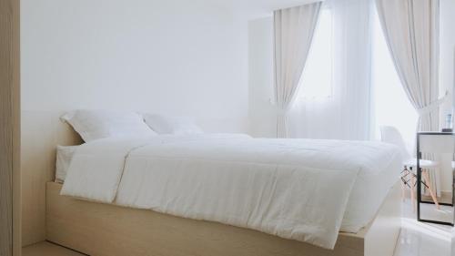 Evenciio Apartment Margonda客房内的一张或多张床位