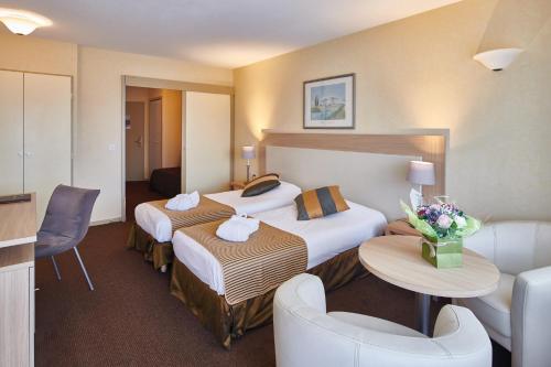 艾克斯莱班马尔利奥布洛斯别墅Spa酒店的酒店客房,设有两张床和一张沙发