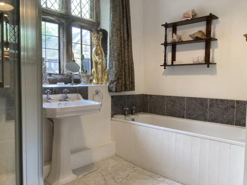 Matlock BankRiber Hall Manor的浴室配有盥洗盆、浴缸和盥洗盆