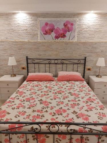 巴里Mivigio的一间卧室配有一张带花卉床罩的床