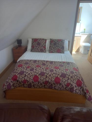 UllenhallShepherds Loft的一间卧室配有一张带鲜花床罩的床