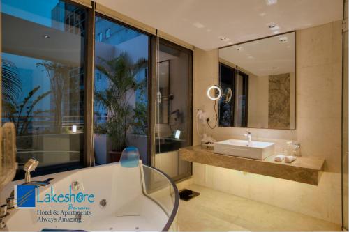 达卡巴纳尼湖岸酒店的带浴缸、水槽和镜子的浴室