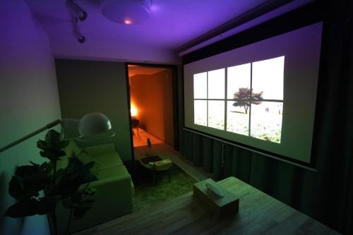 札幌Glass Shiseikan的带沙发和窗户的客厅