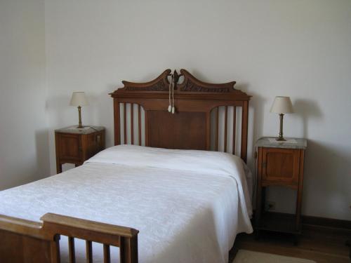 阿尔瓦伦加Vila Guiomar - Casa da Eira的一间卧室配有木床和2个床头柜