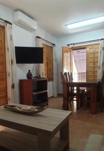 比利亚霍约萨Apartamento San Agustín Playa的客厅配有桌子和电视