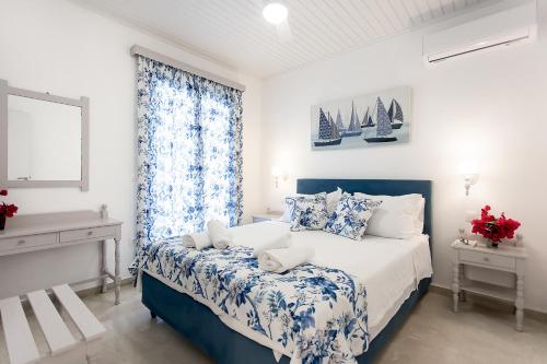 科孚镇oliva e mare luxury suite的卧室配有蓝色和白色的床和窗户。