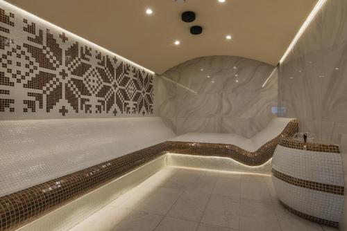 特里亚夫纳Wine & SPA Hotel Chukara的一间设有床铺和浴缸的客房