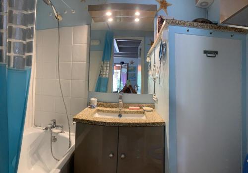 拉帕尔米雷« La Palmeraie » Villa résidentielle avec piscine的一间带水槽、浴缸和镜子的浴室