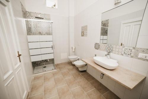 利扎诺Masseria Macchiarola的白色的浴室设有水槽和卫生间。