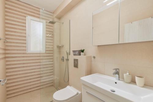 蒂瓦特Petrovic apartmani的带淋浴、卫生间和盥洗盆的浴室