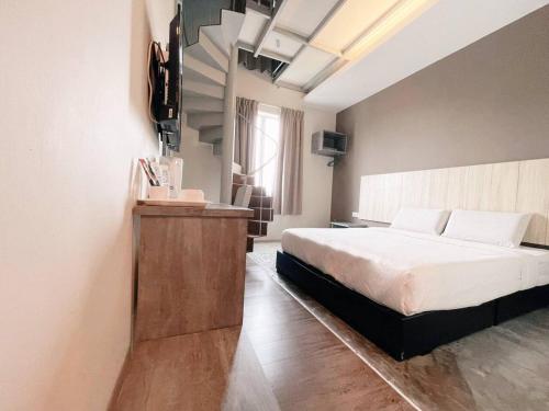 关丹KARANG TIMUR MOTEL的一间卧室配有一张床和一台电视