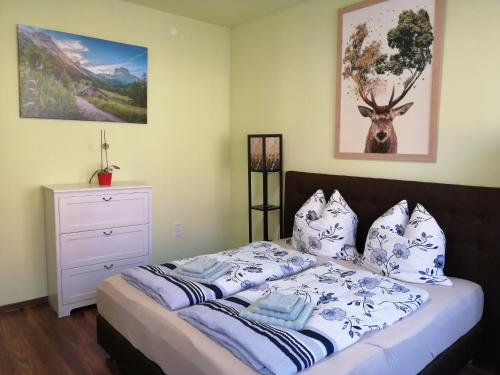 海德克Ferienhaus Heideck的一间卧室配有一张带蓝色和白色枕头的床