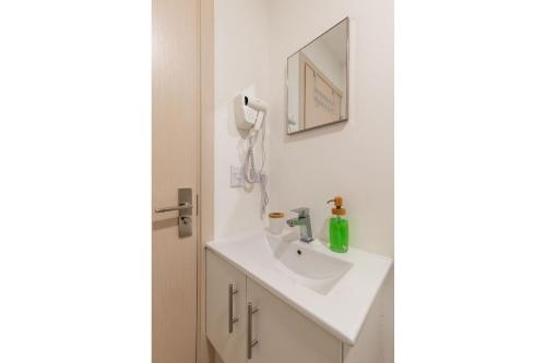 BarrialBoho Chic, Apart- condo cerca de SJO Intl airport的浴室设有白色水槽和镜子