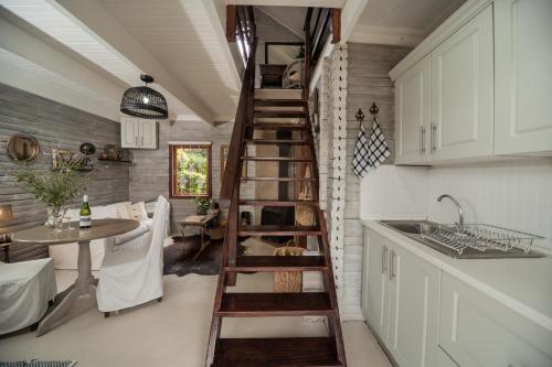 哈内茨堡Viewpoint Cabin 7的厨房设有木制螺旋楼梯,旁边是桌子