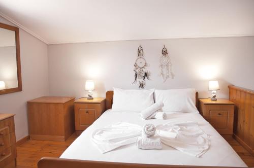 迈加洛丘里STUDIOS ATHENA的卧室配有白色的床单和灯具。