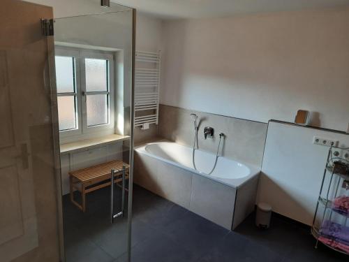 里姆斯廷格Ferienwohnung Fenzl的带浴缸、水槽和窗户的浴室