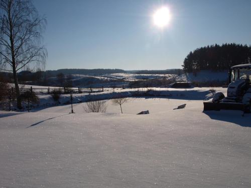 GiławyAgroturystyka Giławy的雪地里带拖拉机的雪地