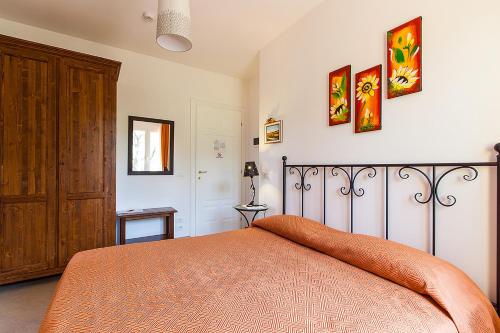圣彼得罗-泰尔梅堡Osteria da Cesare e Locanda的一间卧室配有一张带橙色毯子的床