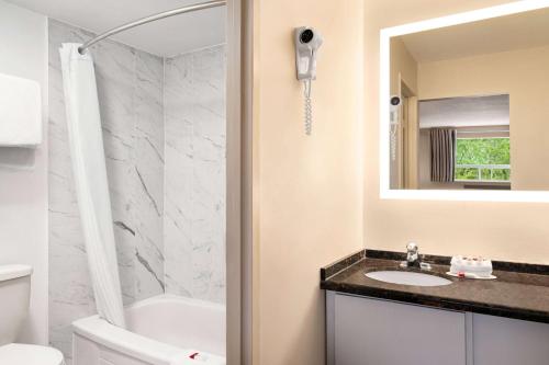 格雷文赫斯特格雷文赫斯特豪生酒店的一间带水槽、卫生间和镜子的浴室