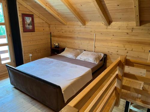比耶洛波列Cottage Ravna Rijeka的小木屋内一间卧室,配有一张床