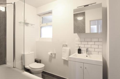 伦敦Lovely two bedroom apartment in London Old Street的白色的浴室设有卫生间和水槽。