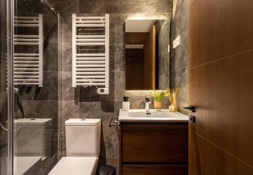 贝尔维尔德赛当亚CERDANYA MOUNTAIN RESIDENCES的一间带水槽、卫生间和镜子的浴室