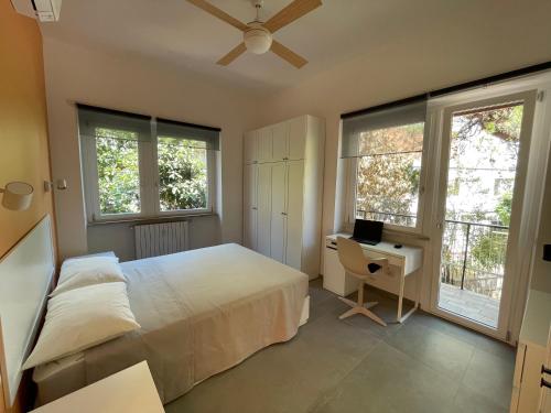 罗马Casa Marconi的卧室配有一张床、一张书桌和窗户。