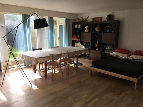 欧登塞Quiet villa apartment close to everything的客厅配有桌子和床。