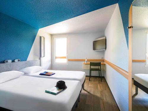 沃雷普格勒诺布尔沃雷普宜必思快捷酒店的一间酒店客房,设有两张床和电视
