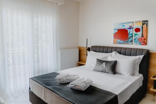 亚历山德鲁波利斯ALEXANDRA Boutique Residence Seaside的一间卧室配有一张床,上面有两条毛巾