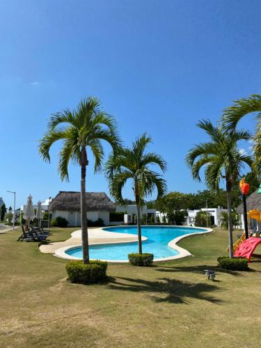 CocléModerna casa con piscina a 10 min de la playa的公园内种有棕榈树的游泳池