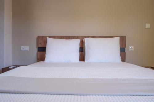 扎戈拉Μελίτη Pelion Luxury Living的一张带白色床单的床和两个枕头