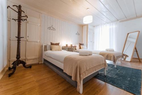奥比多斯Casa Amarela的一间大卧室,配有两张床和一张桌子