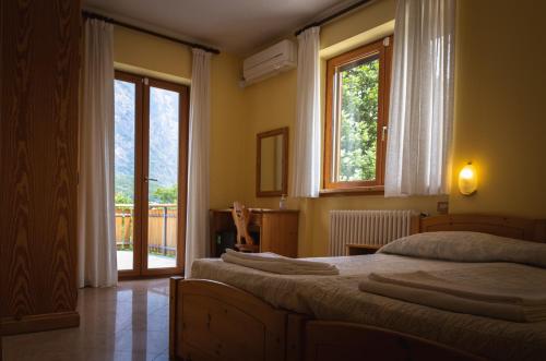 GordonaAgriturismo la campagnola的一间卧室设有两张床和大窗户