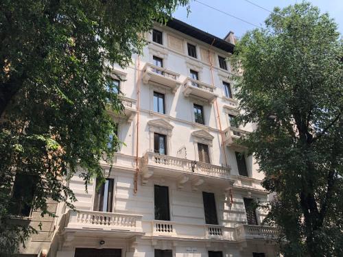 米兰Sant'Ambrogio with charme的一座大型白色建筑,上面设有阳台