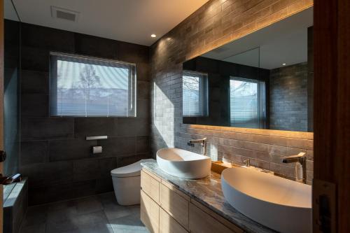 俱知安町Shion的浴室设有2个水槽、卫生间和镜子。
