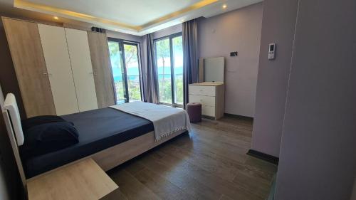 库萨达斯Özel havuz ve deniz manzaralı yeni villa的一间卧室设有一张床和一个大窗户