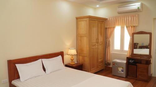 海阳NK Công Đoàn Hải Dương的一间卧室配有一张床、梳妆台和镜子