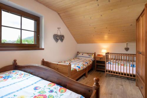 特尔乔夫Chalupa Anička - Terchová的一间卧室配有两张床和一张婴儿床。