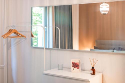 开姆尼茨Stylisches Apartment mit Balkon / Netflix / WIFI的浴室设有镜子和白色架子